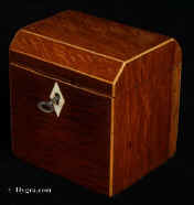 744TC: Partridge wood single compartment tea caddy strung with boxwood and opening to a lidded tea compartment. The top is canted to the front and back. The interior lid is of maple. Both the inside of the lid and the inside of the caddy retains a lot of the original lining. Circa 1790 