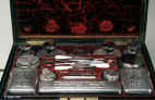JB317: A  very fine and rare brass bound figured rosewood fully fitted traveling/dressing box by D Edwards, with working Bramah lock and countersunk carrying handles, the inside lined in velvet and gold embossed  leather and containing hallmarked silver toped cut lead crystal bottles and jars by Archibald Douglas and having a document wallet and liftout mirror in the lid. Circa 1829.  Enlarge Picture