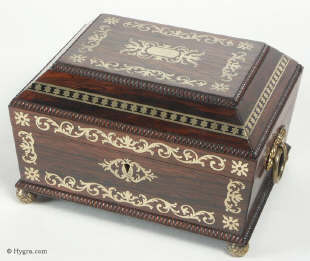 A fully fitted brass inlaid rosewood sewing box with gadrooned edges gilt side carrying handles and gilt feet. Inside the fully fitted sewing tray contains a set of turned ivory spools. Circa 1810. Enlarge Picture