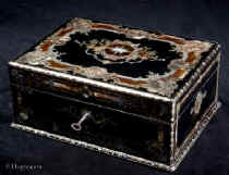 SB500: Antique opulent fully fitted sewing box in ebony profusely inlaid with tortoiseshell, engraved brass, mother of pearl and abalone. The inside has a silk covered lift out tray retaining a set of sewing tools including turned and carved mother of pearl spools with matching tape measure and needle cleaner. A central tray has steel tools with tortoiseshell handles. Circa 1840. Enlarge Picture