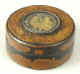 A Vernis Martin (a type of hard varnish/papier mch patented in1744 in France by the Martin brothers), snuff box lined in red tortoiseshell. Over the hard surface there is a layer of gold before the final varnish. The center has a picture of a lady being serenaded by a youth. The figures are fashioned in gold and framed in dots of cut steel.