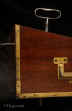 WB475: Important rare brass bound solid mahogany ship captain's campaign writing box with complex secret drawers and compartments including a false bottom. The box retains its original green felt writing surface, pounce and inkwell. The box also has a screw down mechanism enabling it be attached to a table. There is also a reading stand which is attached to the top surface when the box is held at an angle with an adjustable hinged brass catch. Circa 1800. Enlarge Picture